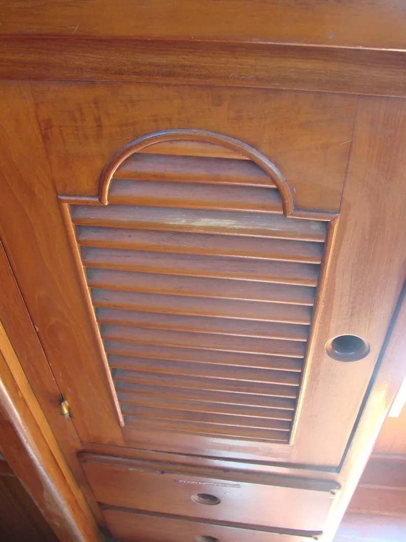 Slide: The Image of Wooden cabinet door with slats and handle inside a yacht. - 22