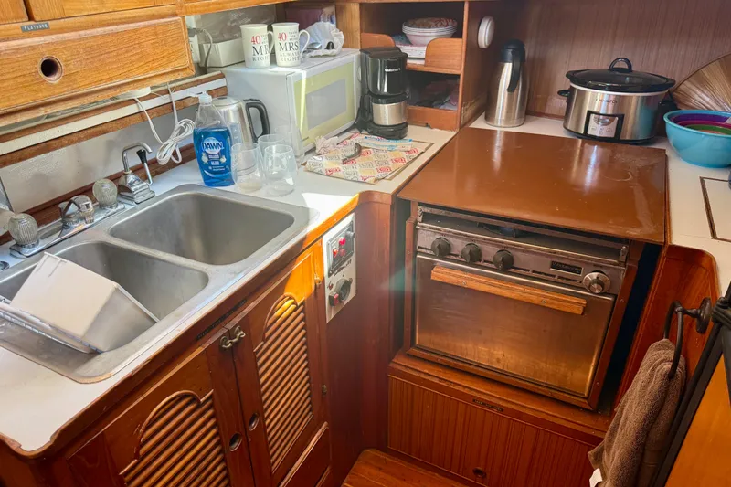 Slide: The Image of 1981 Kha Shing Sundeck ACMY kitchen with sink, stove, and appliances. - 13