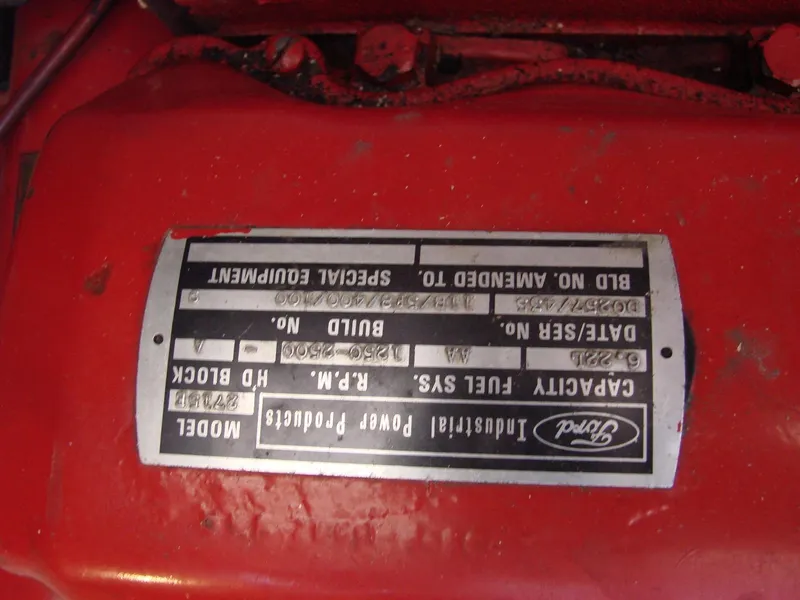 Slide: The Image of A red engine placard with technical details and a Ford logo. - 35