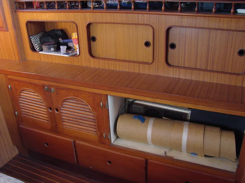 Slide: The Image of Interior of a boat with wooden cabinets and shelves providing storage space. - 23