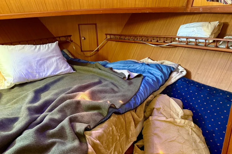 Slide: The Image of Cozy cabin interior of 1981 Kha Shing Sundeck ACMY with bedding and pillows. - 17