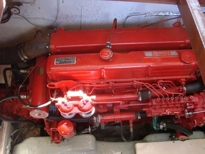 Slide: The Image of A red engine in a boat's engine room, surrounded by pipes and cables. - 29