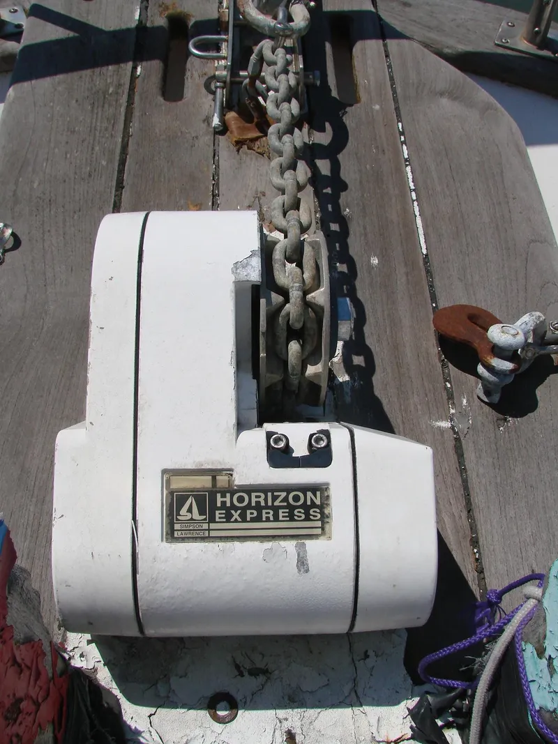 Slide: The Image of A Horizon Express windlass on a wooden deck with chain and ropes. - 45