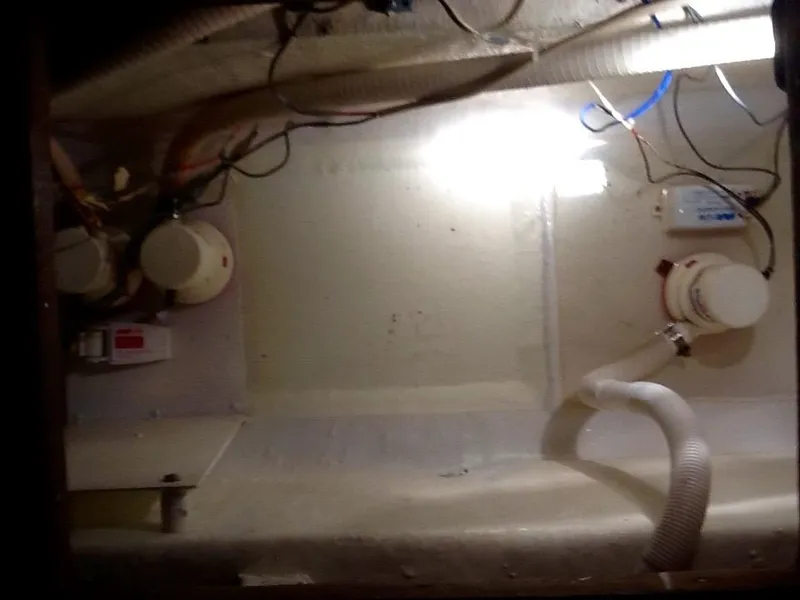 Slide: The Image of An engine room with hoses and pumps inside a boat. - 18