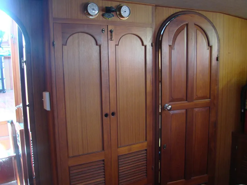 Slide: The Image of Interior of a yacht with wooden doors and round instruments on the wall. - 24