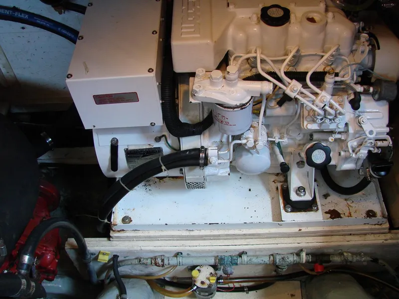 Slide: The Image of A clean engine room with a white engine and various hoses and cables. - 40