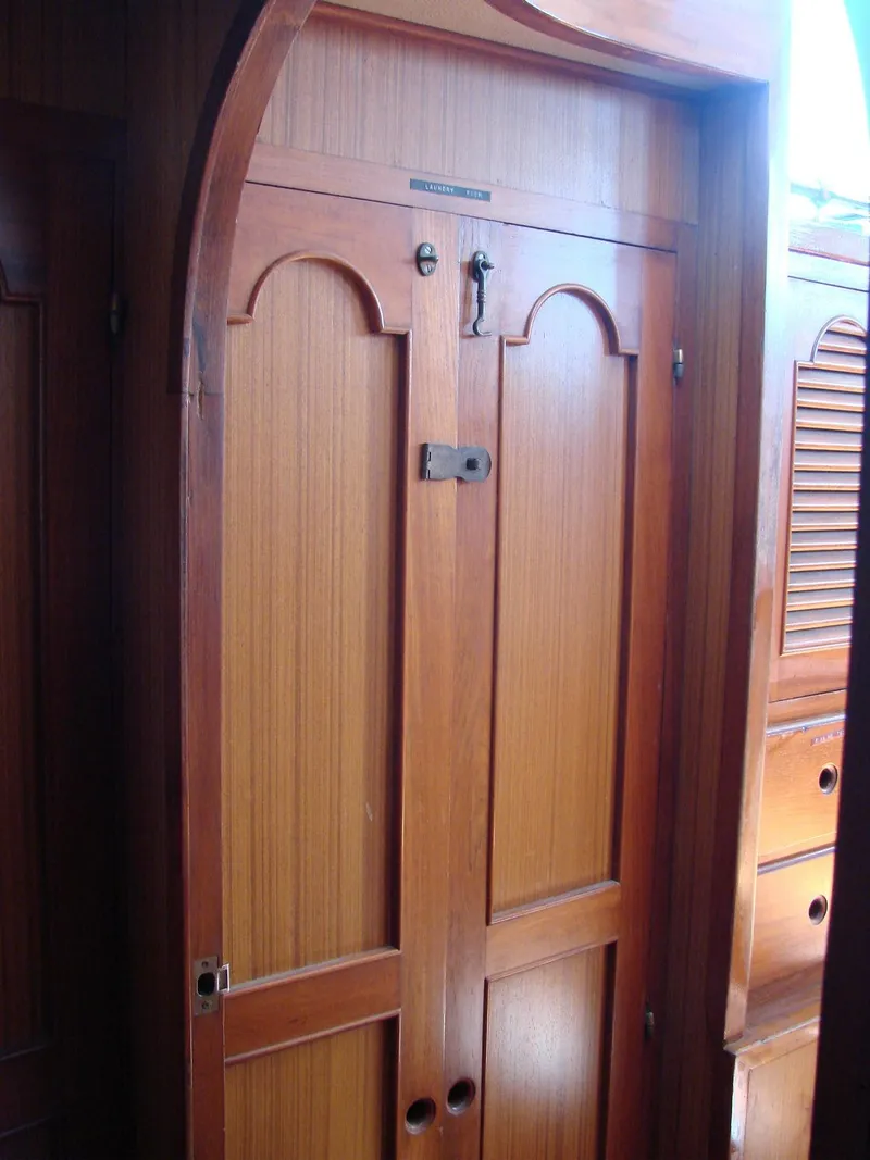 Slide: The Image of Wooden cabinet doors in a yacht cabin with elegant detailing and a small latch. - 28