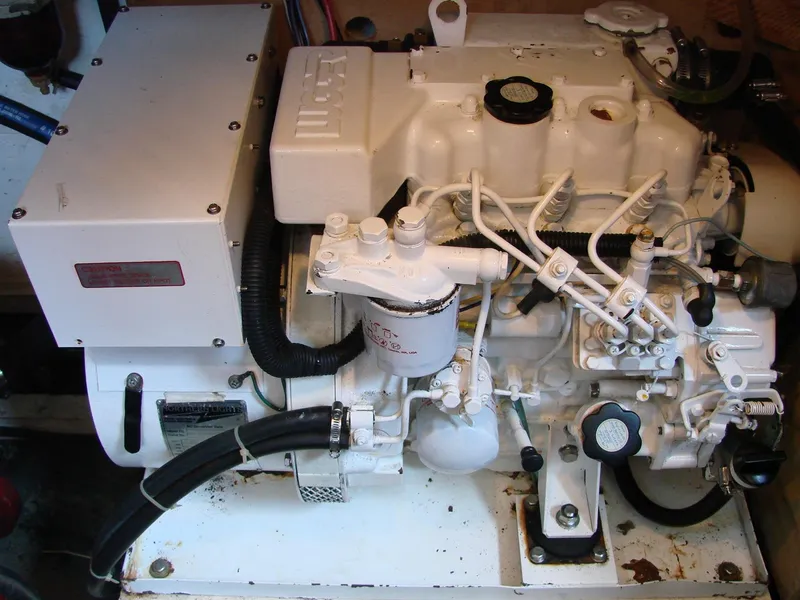 Slide: The Image of A clean, white boat engine with various hoses and cables is visible. - 43