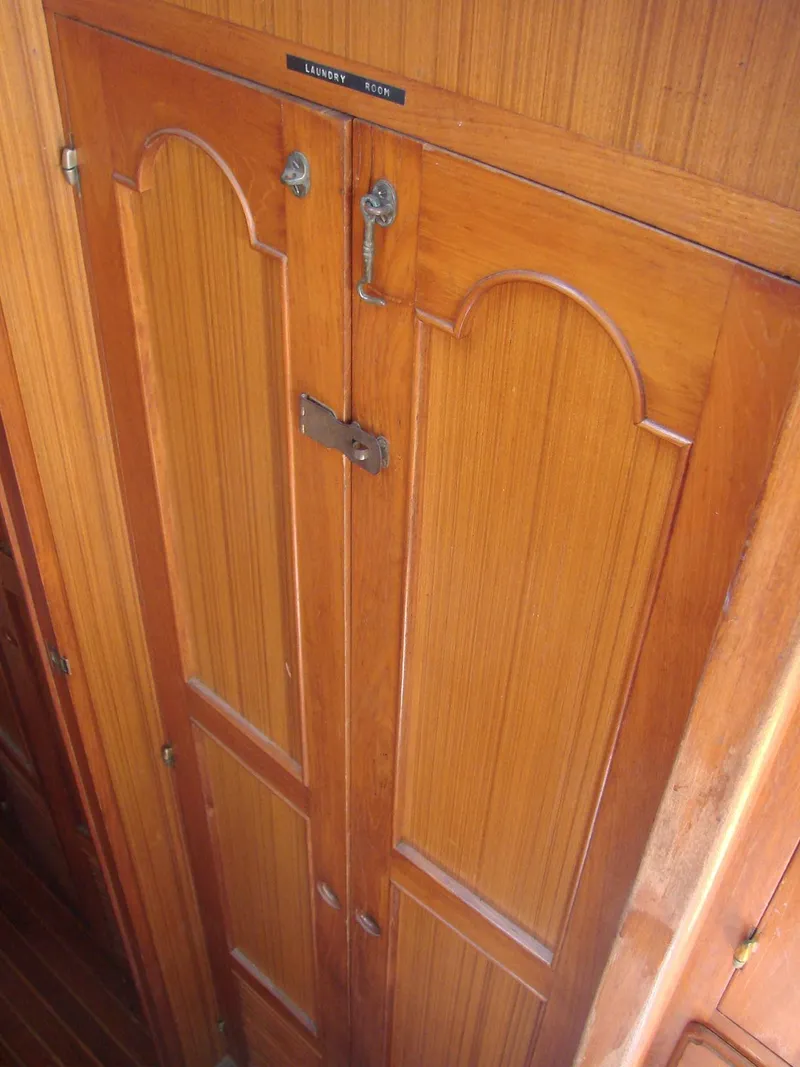 Slide: The Image of Wooden doors with decorative panels inside a boat, likely a cabinet door. - 21
