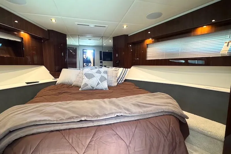 Slide: The Image of Luxurious bedroom interior of 2023 Cruisers Yachts 50 Cantius with elegant bedding and wood accents. - 39