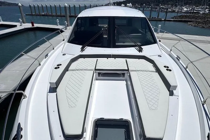 Slide: The Image of 2023 Cruisers Yachts 50 Cantius luxury yacht docked at marina, featuring spacious deck. - 12