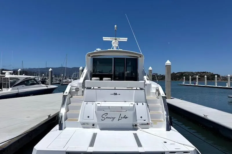 Slide: The Image of 2023 Cruisers Yachts 50 Cantius docked at marina under clear blue sky. - 4