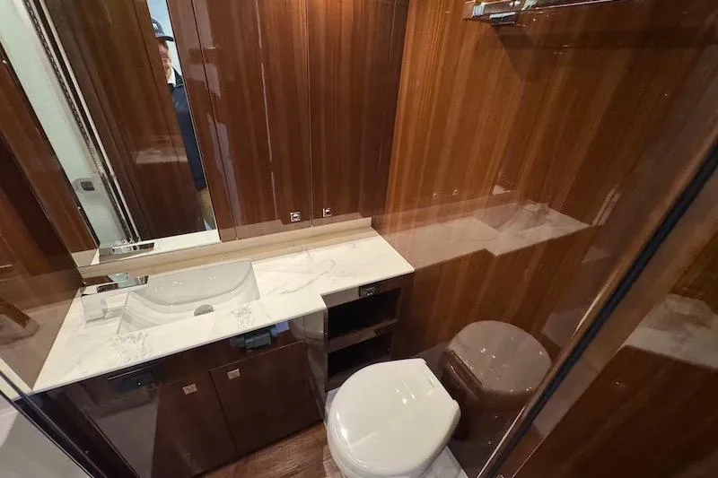 Slide: The Image of Luxurious bathroom in 2023 Cruisers Yachts 50 Cantius with wood paneling and modern fixtures. - 49