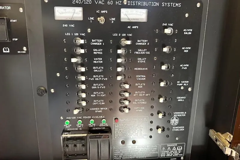Slide: The Image of Electrical distribution panel on 2023 Cruisers Yachts 50 Cantius, showcasing various system controls. - 36