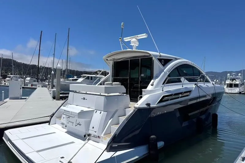 Slide: The Image of 2023 Cruisers Yachts 50 Cantius docked at marina under clear blue sky. - 5