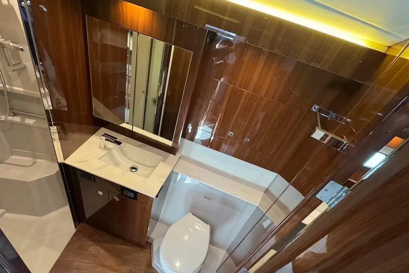 Slide: The Image of Luxurious bathroom in 2023 Cruisers Yachts 50 Cantius with elegant wood finish and modern fixtures. - 45