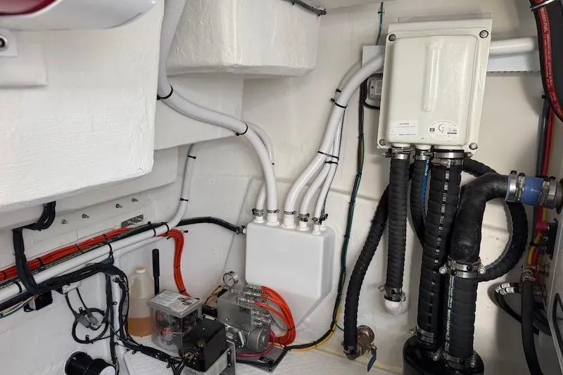 Slide: The Image of Engine room of 2023 Cruisers Yachts 50 Cantius, showcasing wiring and plumbing systems. - 69