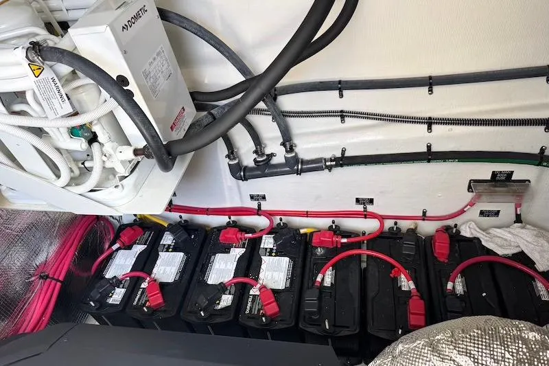 Slide: The Image of Engine room of 2023 Cruisers Yachts 50 Cantius with batteries and wiring. - 71