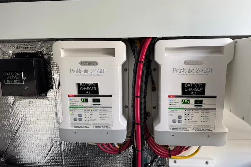 Slide: The Image of Battery chargers in 2023 Cruisers Yachts 50 Cantius, featuring ProNautic 24-30P models. - 74