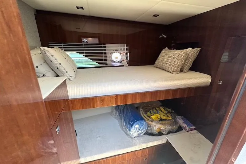 Slide: The Image of 2023 Cruisers Yachts 50 Cantius cabin with bunk beds and wooden interior. - 33