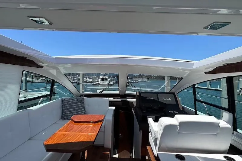 Slide: The Image of Interior view of 2023 Cruisers Yachts 50 Cantius with luxurious seating and helm. - 23