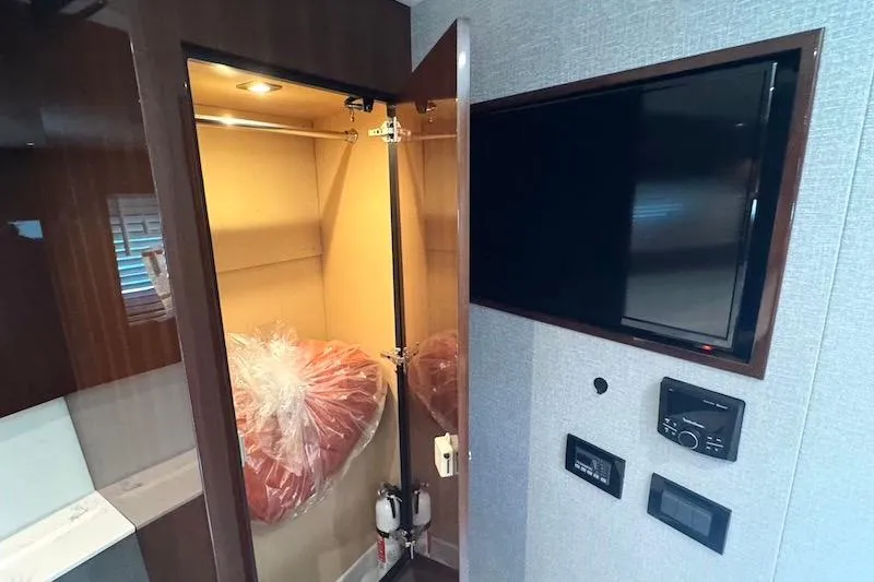 Slide: The Image of 2023 Cruisers Yachts 50 Cantius interior with closet and wall-mounted TV. - 42