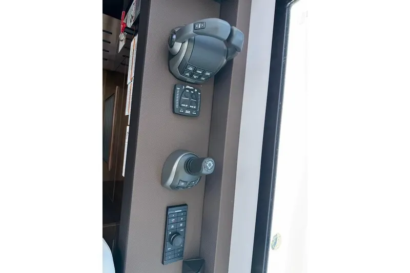Slide: The Image of Control panel of 2023 Cruisers Yachts 50 Cantius, featuring advanced navigation controls. - 27