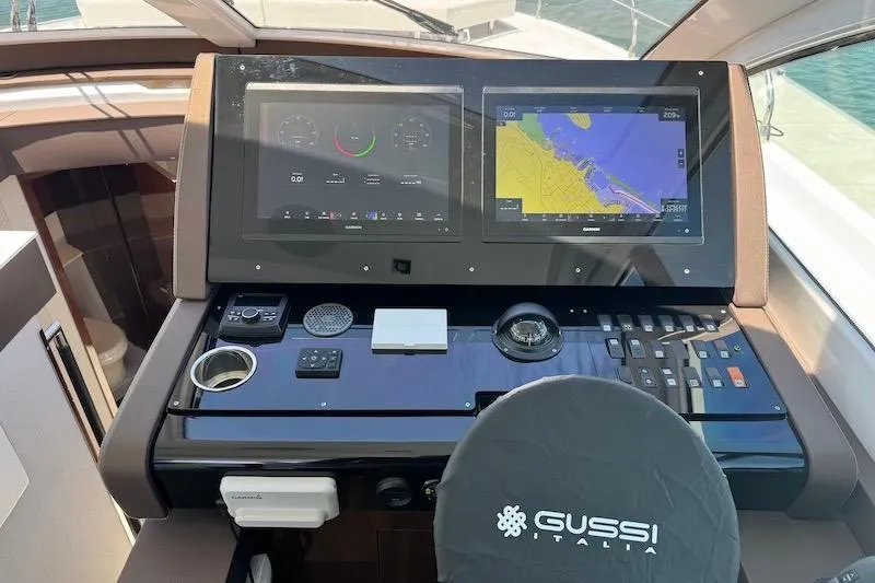 Slide: The Image of Helm of 2023 Cruisers Yachts 50 Cantius with navigation screens and controls. - 28