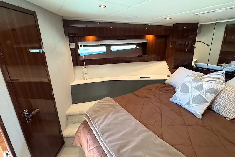 Slide: The Image of Luxurious bedroom interior of 2023 Cruisers Yachts 50 Cantius with elegant wood finishes. - 40