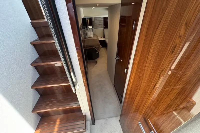 Slide: The Image of Interior view of 2023 Cruisers Yachts 50 Cantius, featuring elegant wood finishes and cozy cabin. - 46