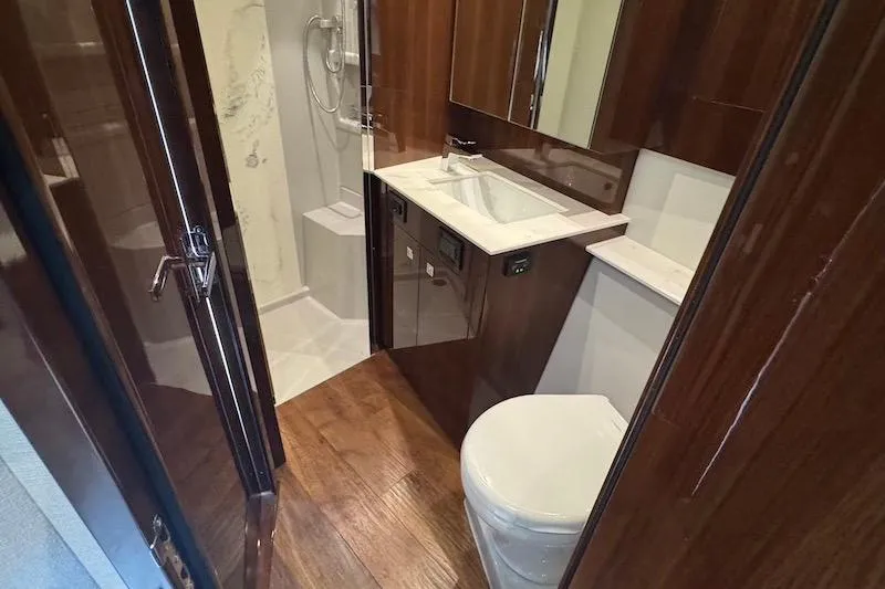 Slide: The Image of Luxurious bathroom in 2023 Cruisers Yachts 50 Cantius, featuring modern fixtures and elegant wood finishes. - 43