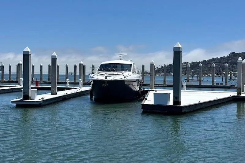 Slide: The Image of 2023 Cruisers Yachts 50 Cantius docked at a marina under clear blue skies. - 3