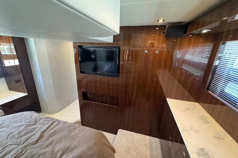 Slide: The Image of Luxurious interior of 2023 Cruisers Yachts 50 Cantius with wood paneling and TV. - 56