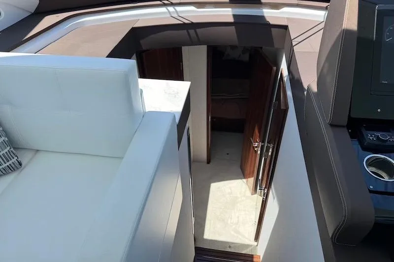 Slide: The Image of 2023 Cruisers Yachts 50 Cantius interior view with white seating and cabin entrance. - 31