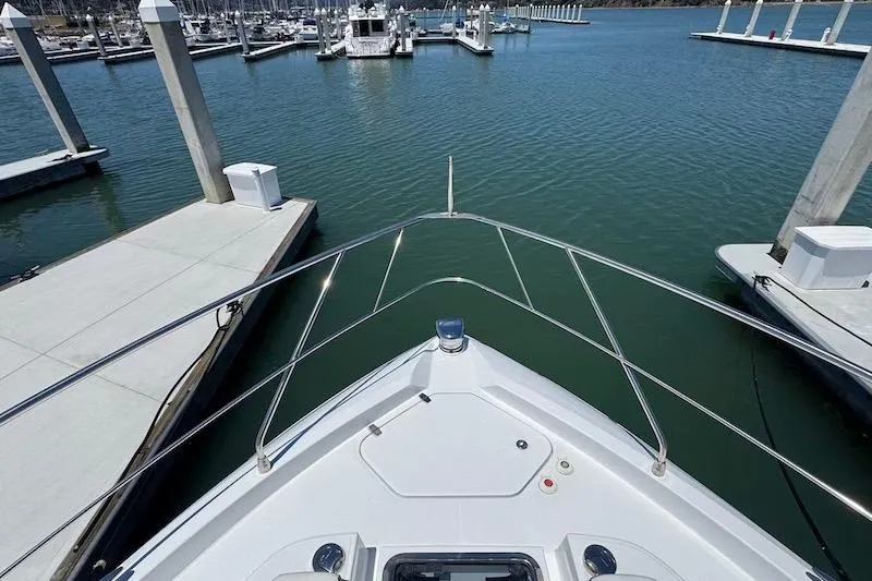Slide: The Image of Bow view of 2023 Cruisers Yachts 50 Cantius docked at marina. - 14