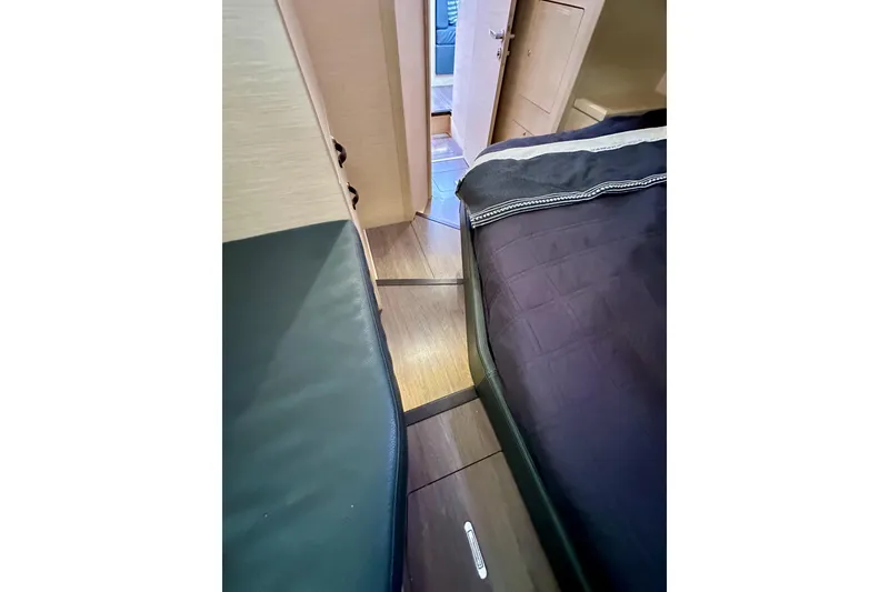 Slide: The Image of Interior cabin view of 2018 Jeanneau 54 yacht, featuring sleek wood flooring and cozy bedding. - 81