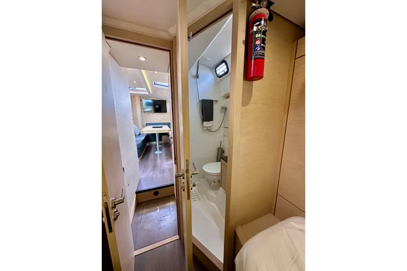 Slide: The Image of Interior of 2018 Jeanneau 54 yacht showing bathroom and living area with modern amenities. - 70