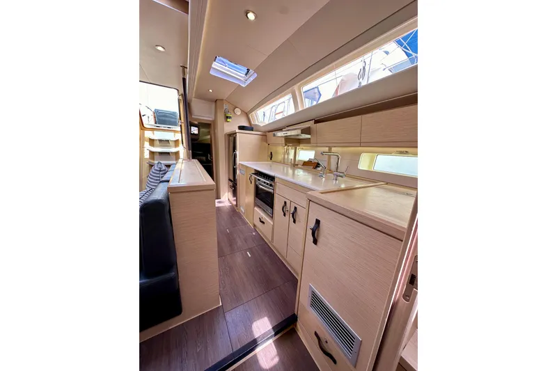 Slide: The Image of Luxurious interior of 2018 Jeanneau 54 yacht with modern kitchen and seating area. - 107