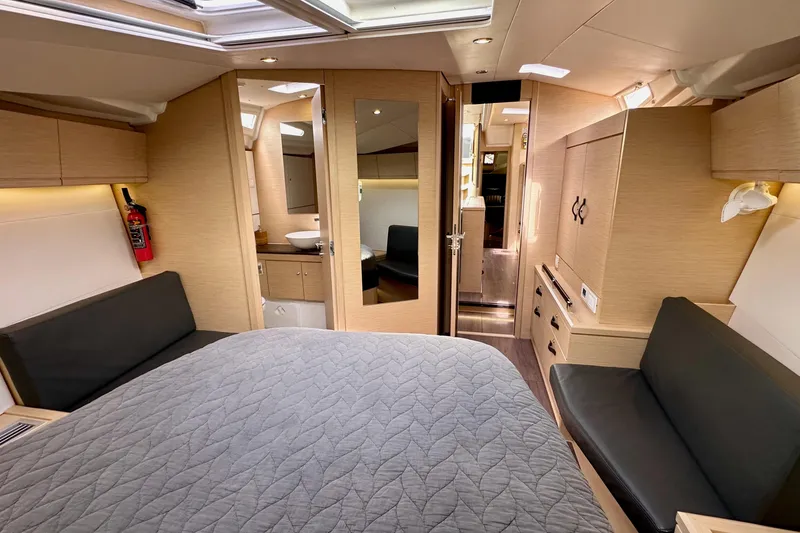 Slide: The Image of Luxurious interior of a 2018 Jeanneau 54 yacht, featuring a cozy bedroom and modern amenities. - 101