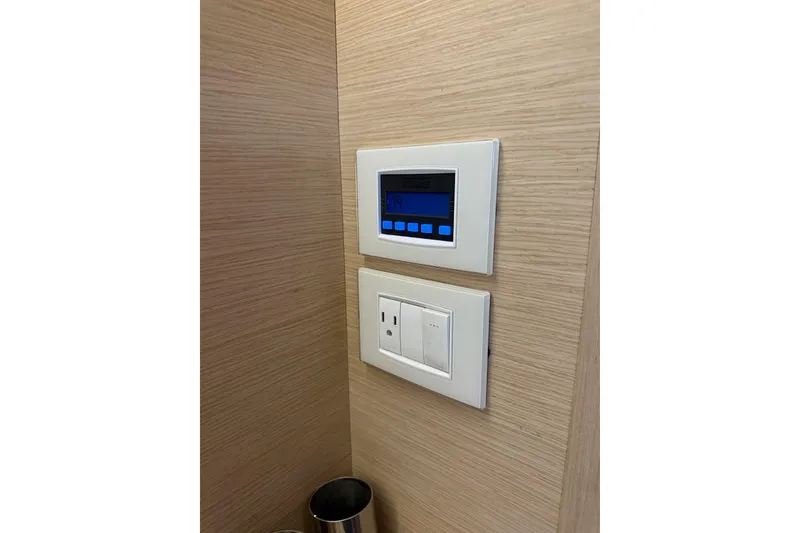 Slide: The Image of Control panel and outlet on Jeanneau 54 yacht, 2018 model, wooden interior. - 72
