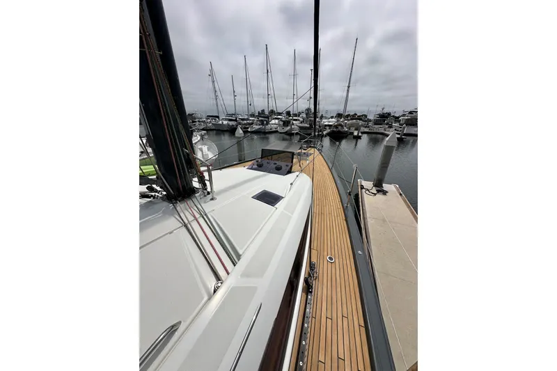 Slide: The Image of 2018 Jeanneau 54 yacht docked at marina, showcasing sleek deck design. - 41