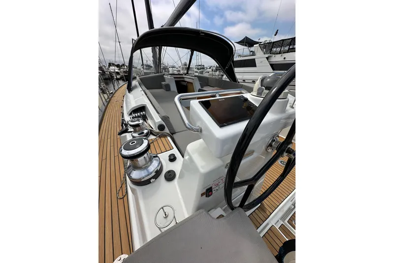 Slide: The Image of 2018 Jeanneau 54 sailboat cockpit with steering wheel and navigation equipment. - 30