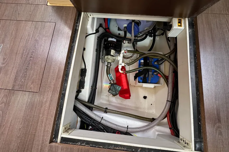 Slide: The Image of Engine compartment of a 2018 Jeanneau 54 yacht, showing mechanical components and wiring. - 115
