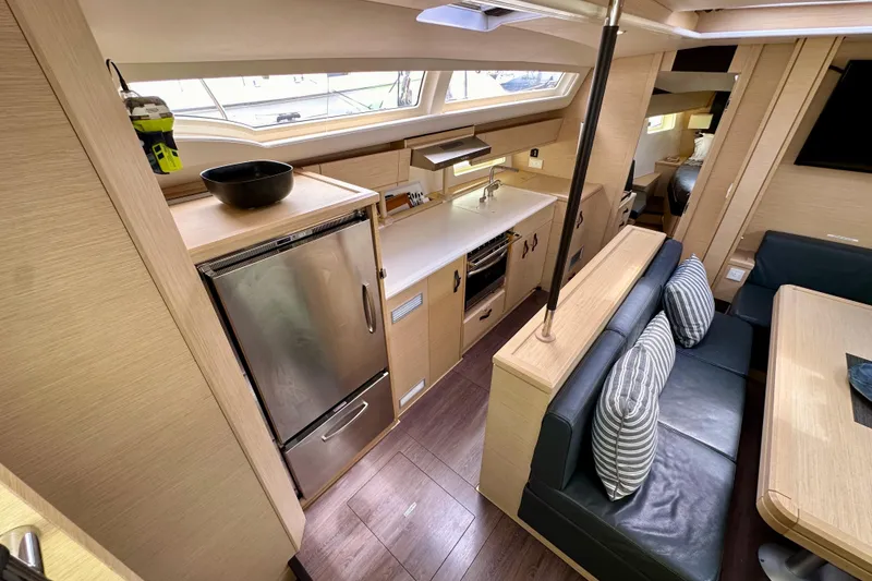 Slide: The Image of Interior of 2018 Jeanneau 54 yacht featuring modern kitchen and dining area. - 63