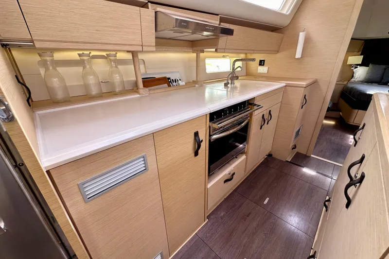 Slide: The Image of Modern kitchen interior of 2018 Jeanneau 54 yacht with sleek cabinetry and appliances. - 91