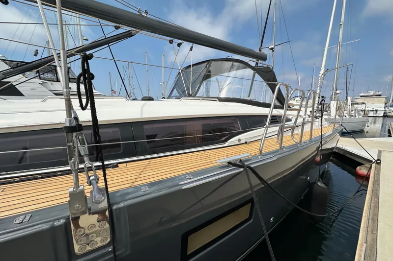 Slide: The Image of 2018 Jeanneau 54 yacht docked at marina, showcasing sleek design and modern features. - 16