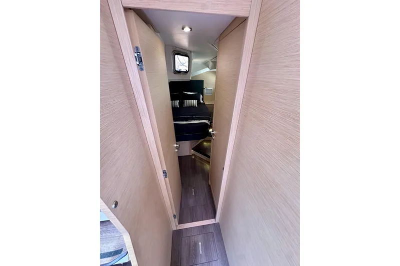 Slide: The Image of Narrow hallway leading to a cozy cabin in a 2018 Jeanneau 54 yacht. - 76