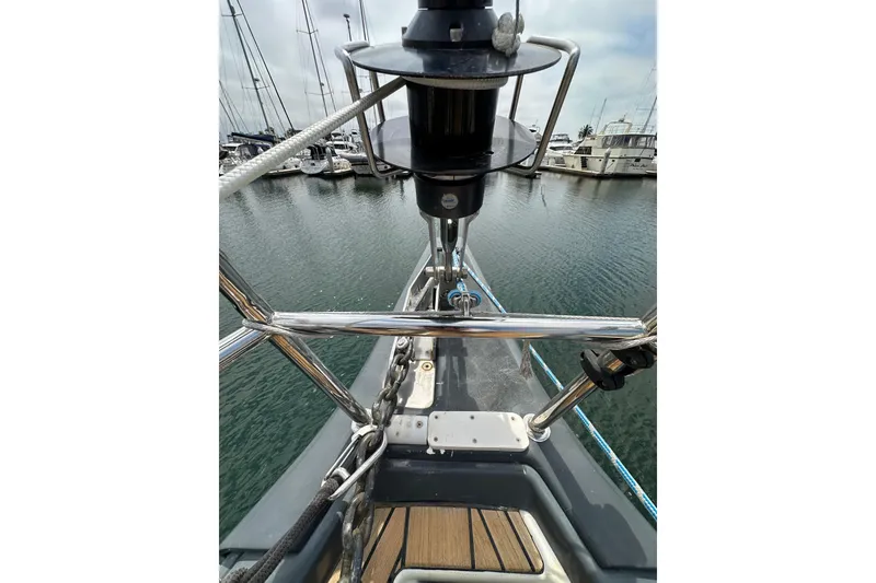 Slide: The Image of Bow view of 2018 Jeanneau 54 sailboat in marina, showcasing anchor and deck details. - 48