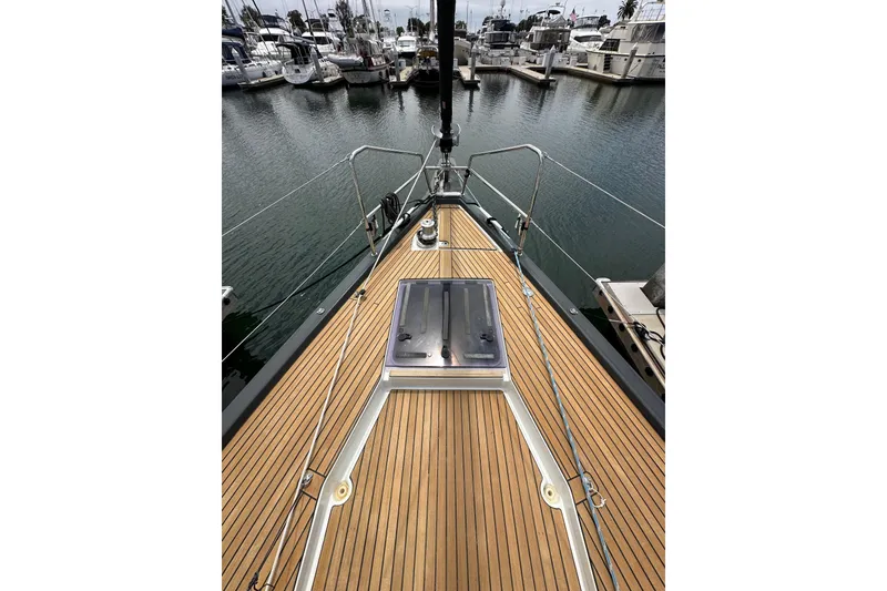 Slide: The Image of Deck view of 2018 Jeanneau 54 yacht in marina, showcasing sleek design and craftsmanship. - 43