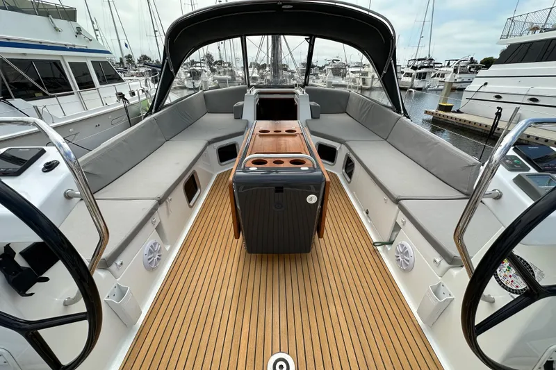 Slide: The Image of Luxurious 2018 Jeanneau 54 yacht cockpit with spacious seating and elegant wood flooring. - 28
